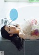 A woman laying on the edge of a bathtub with a speech bubble above her head.