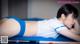 A woman laying on top of a pool table next to a pool cue.