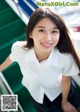 A young woman in a school uniform posing for a picture.