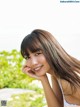 A woman with long brown hair posing for a picture.