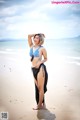 A woman in a bikini standing on a beach.