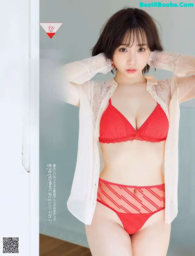 A woman in a red bra and panties posing for a magazine.