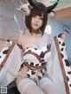 A woman in a cow costume is posing for the camera.