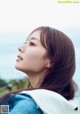 A woman with long brown hair looking up at the sky.