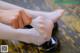 A close up of a person putting on a pair of shoes.